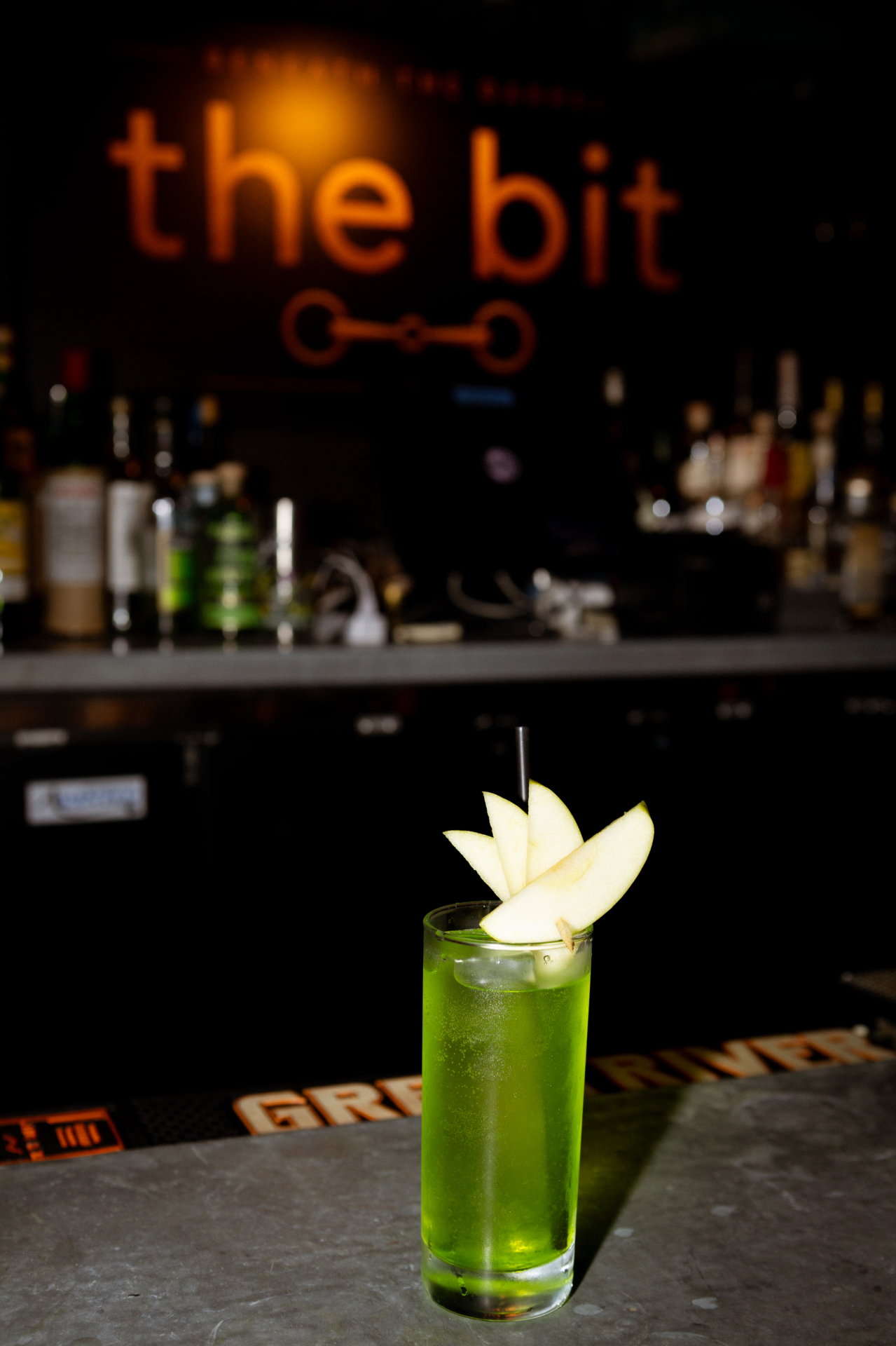 A bright green apple cocktail at the bit
