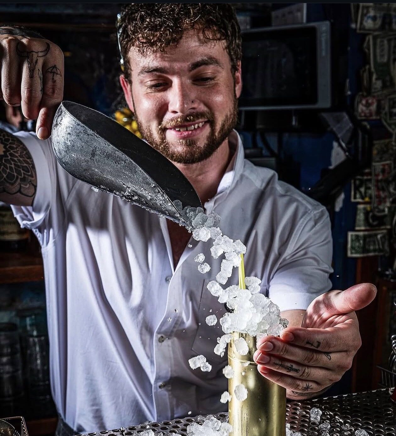 Decker pouring crushed ice into a cocktail